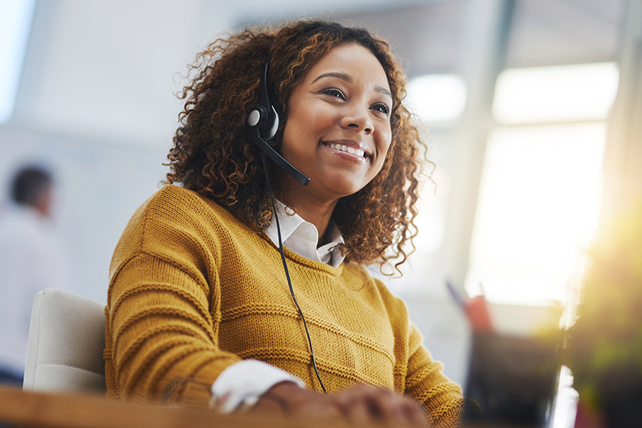 African American woman wearing a headset providing customer support